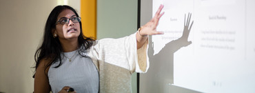 Latina teacher in front of board