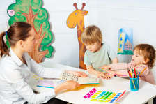 Preschool teacher and students reading