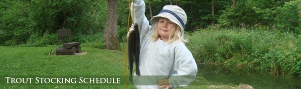 A young girl holding up a trout she caught in a northeast Iowa trout stream.