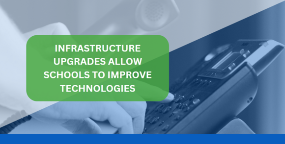 a teacher using a phone handset in a classroom