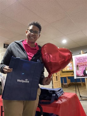 Boy holding up paper heart