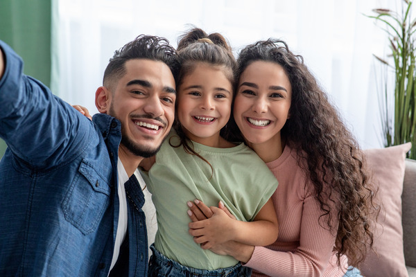 Family of three smiling together