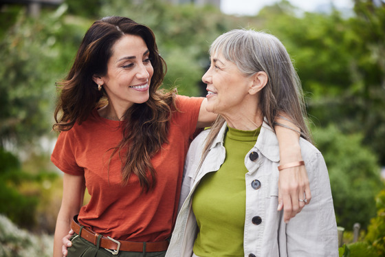 A woman putting her arm around her mother