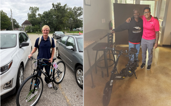 Two men holding bicycles smiling