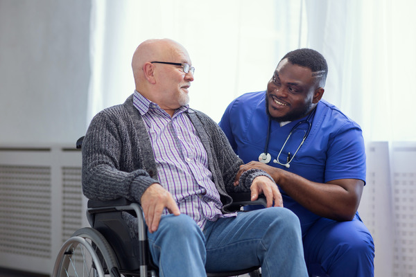 Caretaker visiting with an elderly patient 