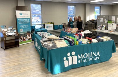 Molina staff posing with promotional materials 