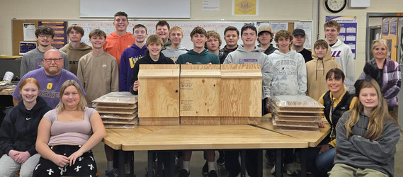 The Geometry in Construction class showing off their completed bat house prototypes and 12 ready to assemble kits.