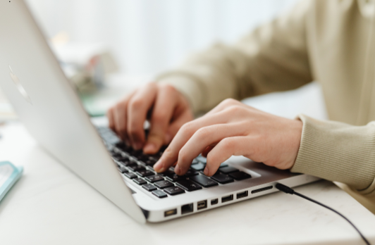 Woman typing on a laptop