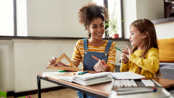 Woman and her daughter sitting at a table