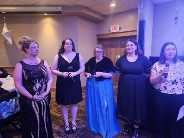 Picture of attendees in formal attire at a dance 