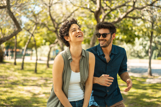 A man and woman walking outdoors 