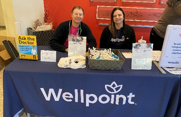Wellpoint staff sitting at a booth