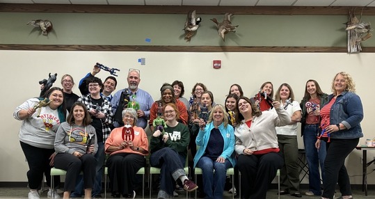 Volunteer Iowa staff gathered together sharing their superhero persona dolls