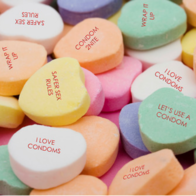 Valentine's Day candy hearts with with messages like "I Love Condoms", "Let's Use a Condom", and "Safer Sex Rules"