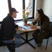 Navigator sits with client at a table to fill out an application