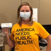 Immunization coordinator holds a box of COVID-19 vaccine