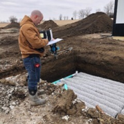 Environmental health specialist inspects a septic system