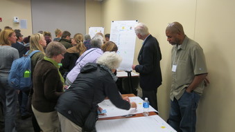 A photo of people dot voting at the Climate Action Meeting in Iowa City.
