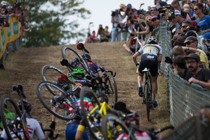 Image of cyclocross athletes crashing on a mud course