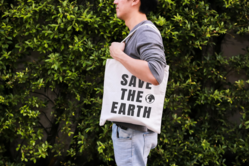 A man holding a reusable bag. 