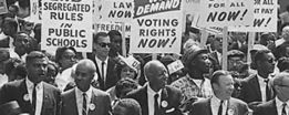 A march supporting the voting rights of African Americans is shown. 