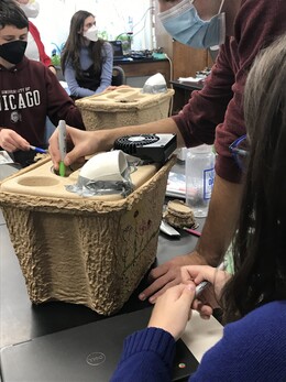 Climate Resilience Corps members assemble DIY air conditioning units that can be used in an emergency.
