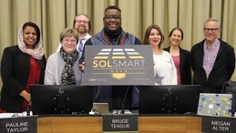 City Council members are pictured with the SolSmart Gold plaque