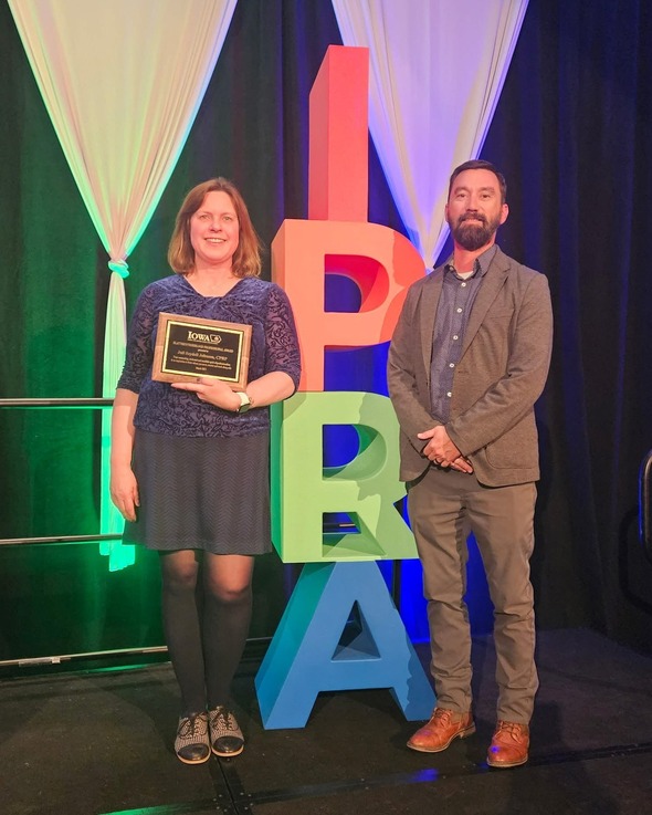 Juli Seydell Johnson standing with Geoff Hubbard in front of IAPRA (Iowa Parks and Recreation Association) display 