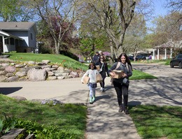 Energy Blitz volunteers are shown delivering energy saving kits