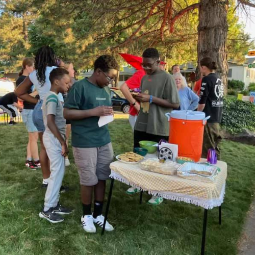 OutAbout event in Draper, Utah shows young boys enjoying drinks and sweets at a neighborhood stop