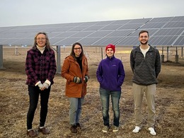 climate ambassadors are pictured in front of the airport solar array