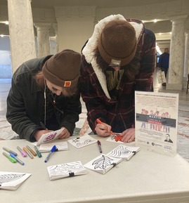 Two participants draw on cards. 