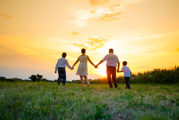 Family walking sunset