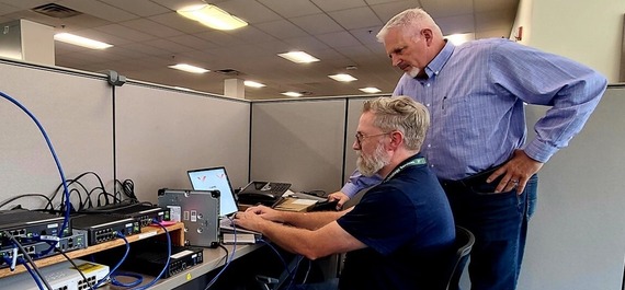 Image of Jon Spence and John Brown configuring hardware