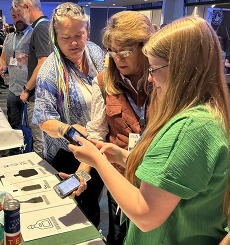 ITS employee demonstrating the use of the handheld devices