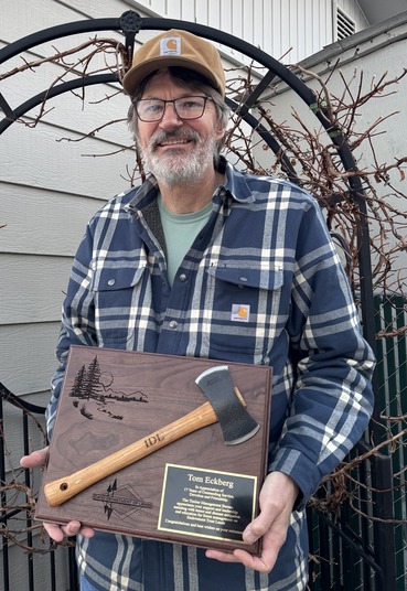 Tom Eckbert holding a plaque