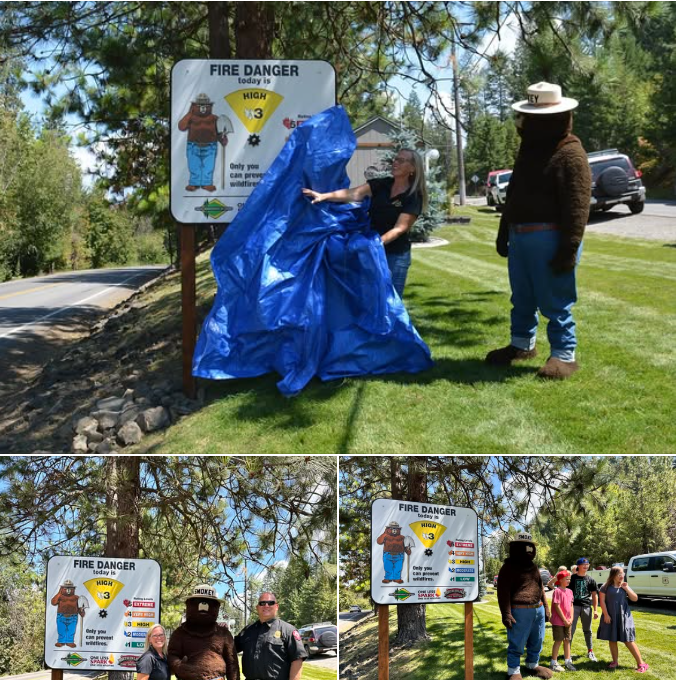 Jen Russell and Smokey Bear unveil a new fire danger sign