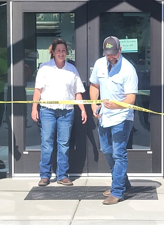 Director cutting a ribbon