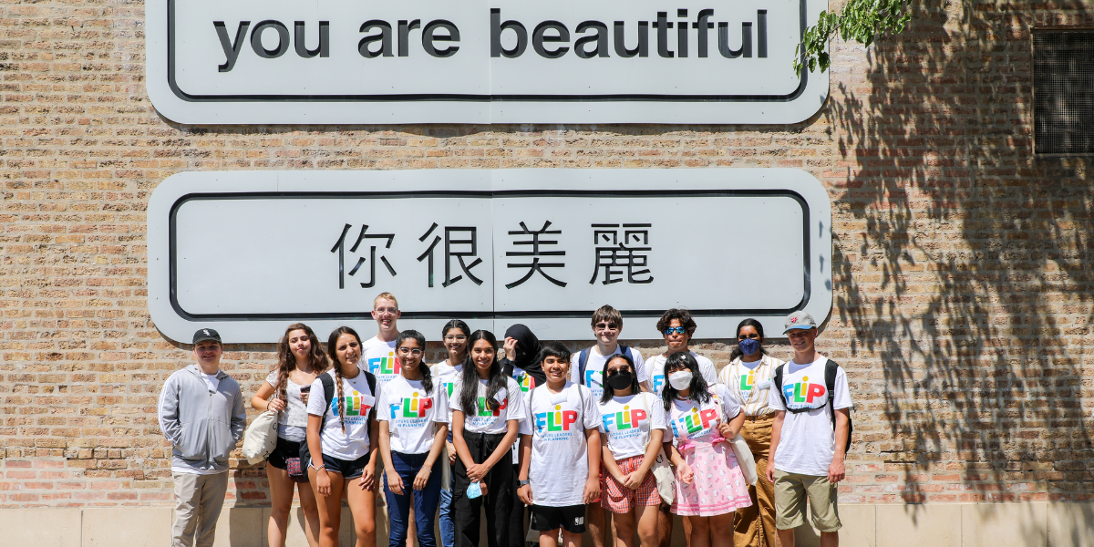 Future Leaders in Planning photo, participants posing in Chinatown in Chicago under a sign that reads you are beautiful