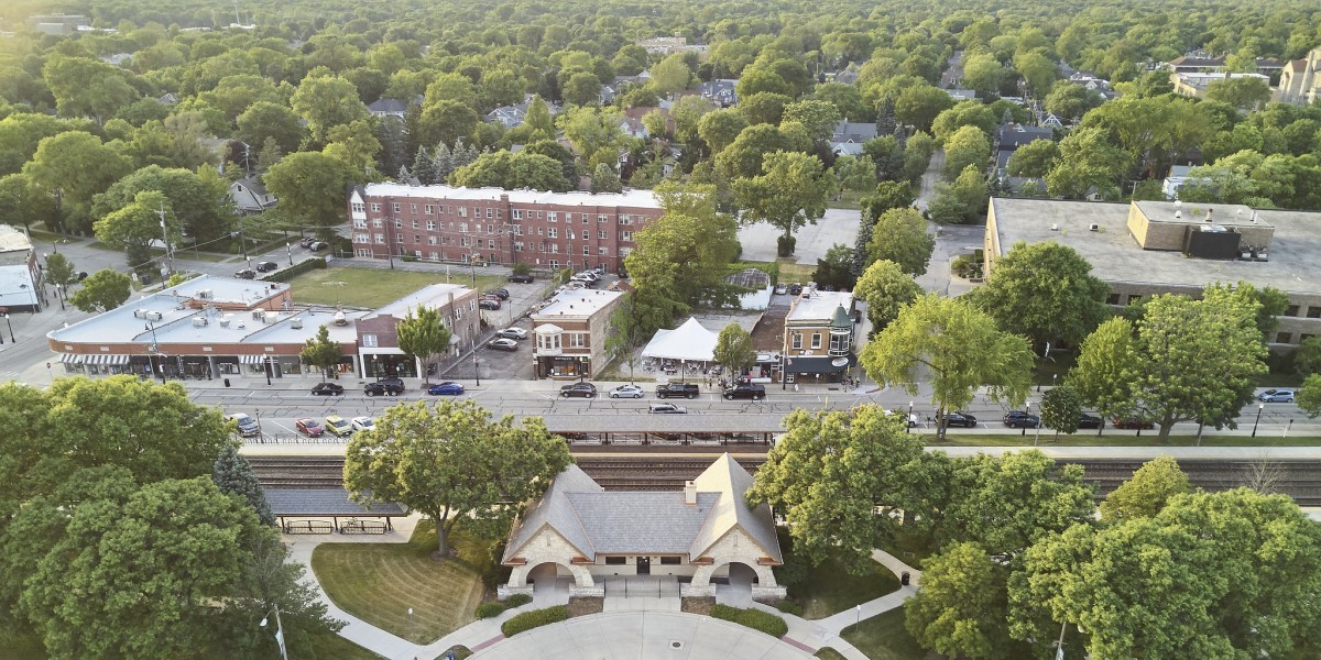 Aerial photo of suburban train station surrounded by other buildings and trees