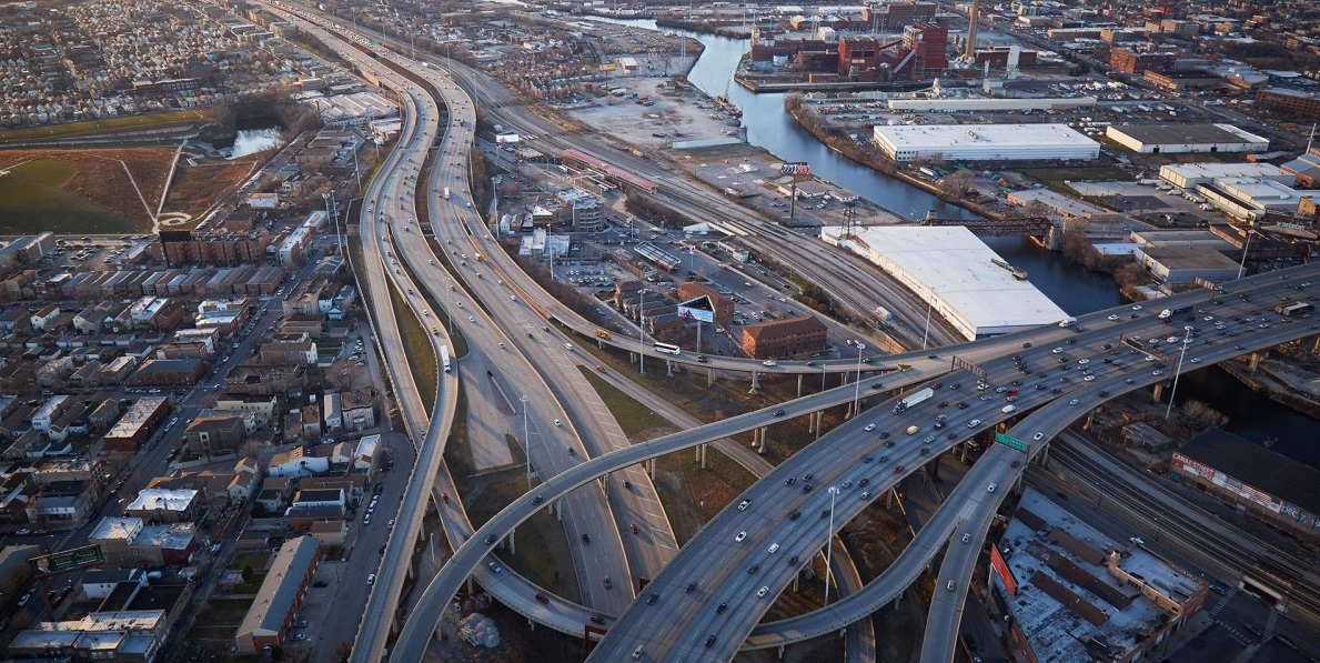 Regional birds eye view of interstate interchange, surround communities, and river waterway
