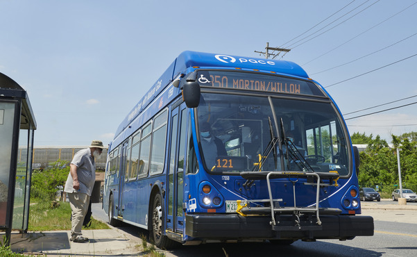 Photograph of a Pace bus at bus stop and a passenger boarding