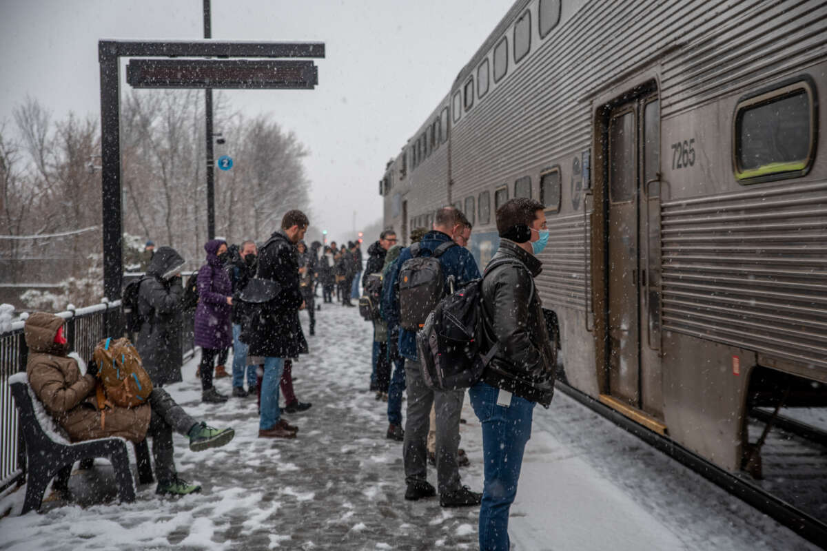 Commuters boarding Metra commuter rail train on winter day