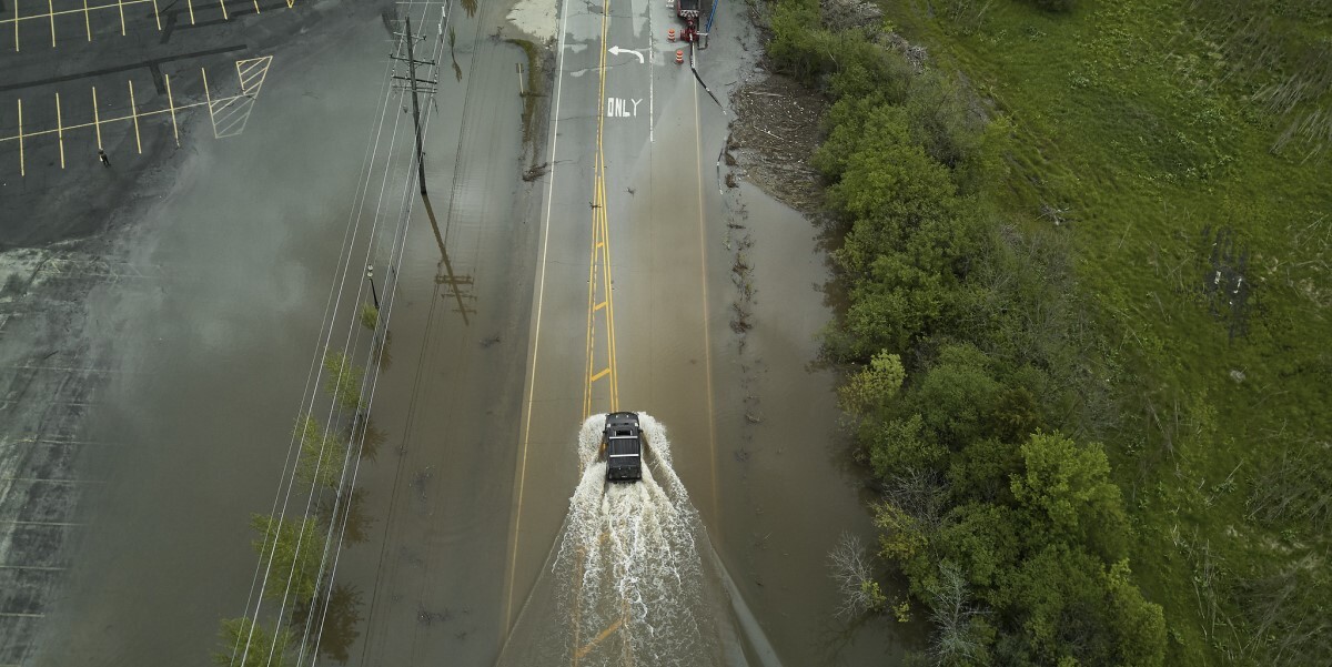 Larve vehicle driving through flooded street
