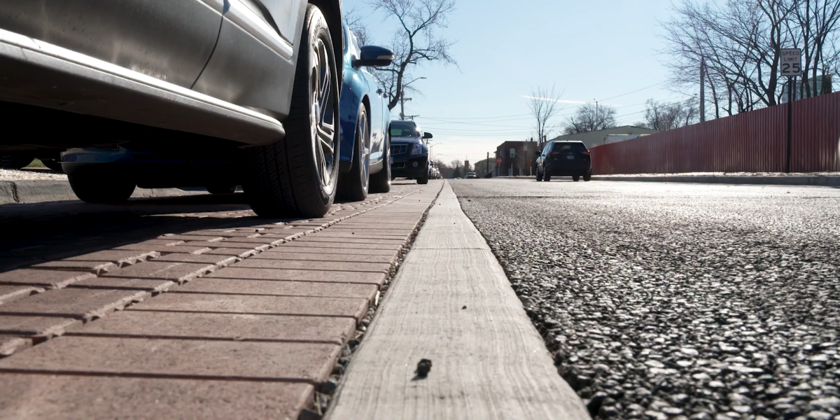 Cars parked on permeable pavers, next to pervious driving lane