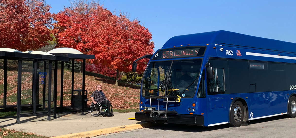 Man using wheelchair boarding an accessible bus