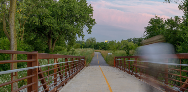 Bike and pedestrian path with cyclist speeding by