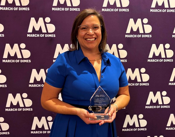 CMAP Executive Director Erin Aleman posing with March of Dimes award