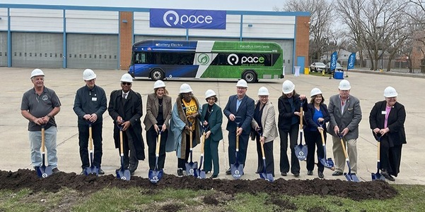 Pace, state, and local officials dig into dirt pile in front of garage