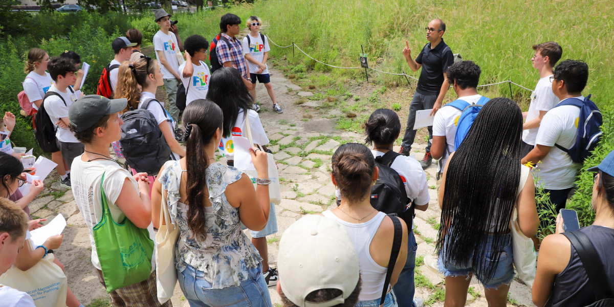 Students gather around a speaker who talks about the park they're in
